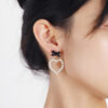 Wholesale Pearl Hollow Heart Shaped Pendant Bow Alloy Earrings