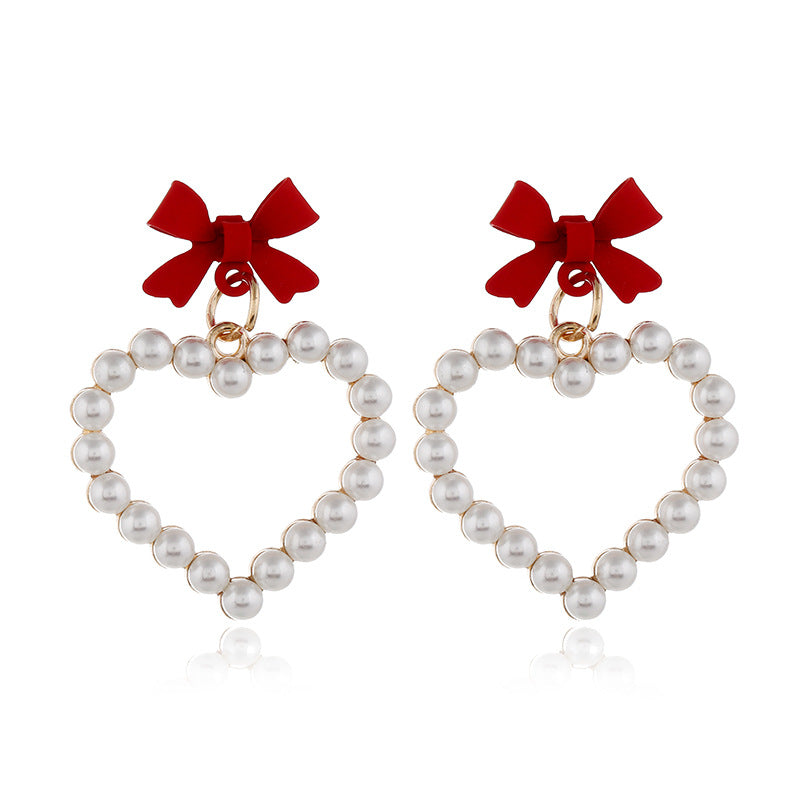 Wholesale Pearl Hollow Heart Shaped Pendant Bow Alloy Earrings