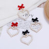 Wholesale Pearl Hollow Heart Shaped Pendant Bow Alloy Earrings