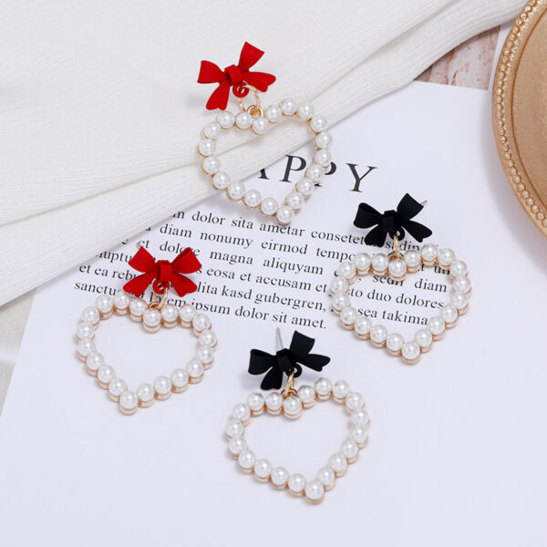 Wholesale Pearl Hollow Heart Shaped Pendant Bow Alloy Earrings