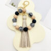 O1CN01HMtyeq1tKvJDDCb2W_2207986825884-0-cib Wholesale Leopard Print White Bottom Wooden Beads Rubber Paint Round Beads PU Tassel Bracelet Keychain