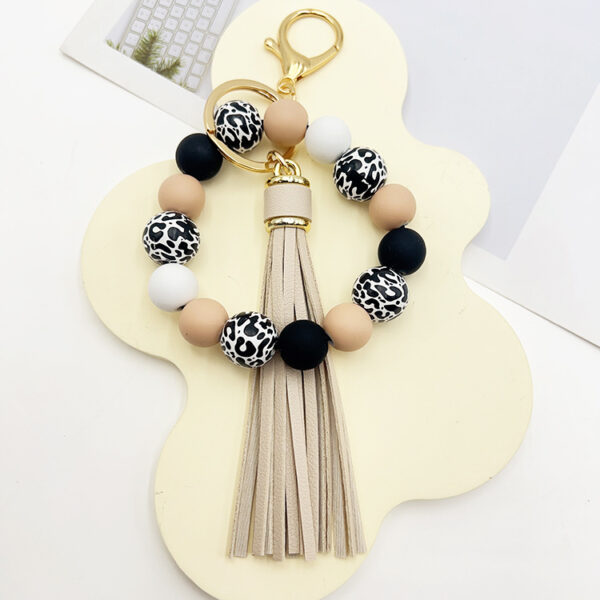 O1CN01HMtyeq1tKvJDDCb2W_2207986825884-0-cib Wholesale Leopard Print White Bottom Wooden Beads Rubber Paint Round Beads PU Tassel Bracelet Keychain