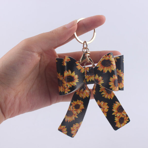 O1CN01IqTOMm1NrNfAMDIo0_2214899881623-0-cib Wholesale Cartoon Aztec Color Bow Leather Keychain