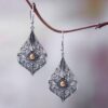 Wholesale Bohemian Retro Style Teardrop-shaped Hollow Pattern Inlaid Gem Alloy Earrings