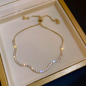 Diamond-encrusted golden wave bracelet
