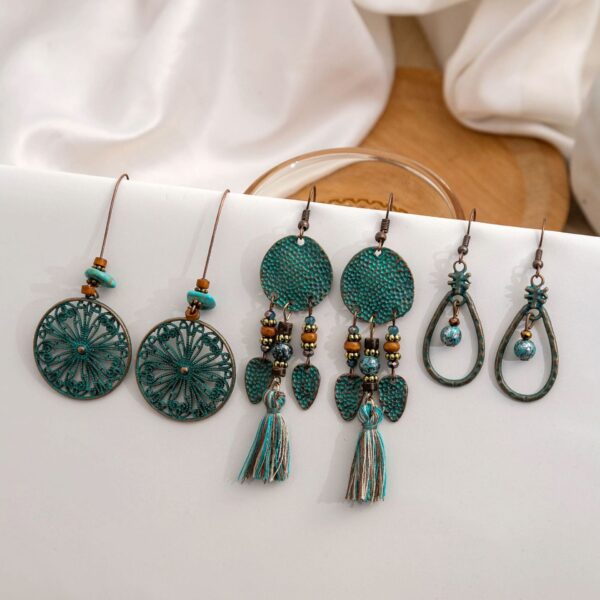 Wholesale Vintage Sunflower Feather Tassels Ethnic Style Round Hollow Alloy Earrings