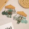 Wholesale Vintage Sunflower Feather Tassels Ethnic Style Round Hollow Alloy Earrings