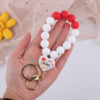 O1CN01juLnai1NrNiDXBolP_2214899881623-0-cib Wholesale Cartoon Love Printed Silicone Beaded Wrist Keychain