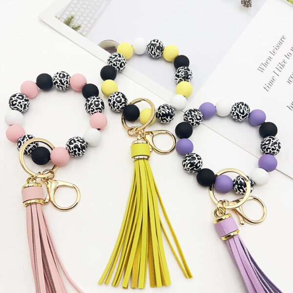O1CN01lNkx131tKvJOzDcSt_2207986825884-0-cib Wholesale Leopard Print White Bottom Wooden Beads Rubber Paint Round Beads PU Tassel Bracelet Keychain