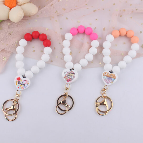 O1CN01n54nj51NrNiFWDpws_2214899881623-0-cib Wholesale Cartoon Love Printed Silicone Beaded Wrist Keychain