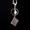 O1CN01o9PZns1DdVVEKF9rI__2210139950239-0-cib Wholesale Alloy Turnable Book Cross Keychain