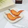 O1CN01p0gDsP1c3enujpLqz_2212435263545-0-cib Wholesale PVC Simulation Orleans Grilled Wings Food Creative Keychain