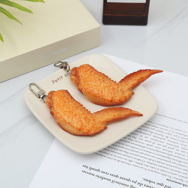 O1CN01p0gDsP1c3enujpLqz_2212435263545-0-cib Wholesale PVC Simulation Orleans Grilled Wings Food Creative Keychain