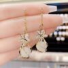 O1CN01uqgxUf1a87YOW3N4D_2215344813284-0-cib Wholesale Zircon Five Petal Flower Cat Eye Stone Personalized Fashion Temperament Earrings