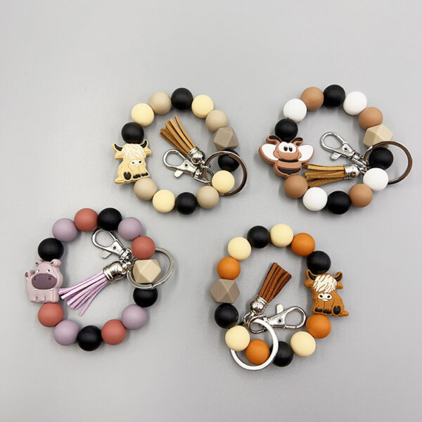 oly-7c1a04efac1ee100ce89a430c331fae0 Wholesale Cartoon Small Animal Yak Silicone Beaded Bracelet Short Tassel Keychain