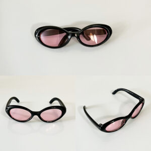 Black framed flat round pink lenses