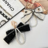 Wholesale Black and white color Chanel style camellia pearl chain bow keychain