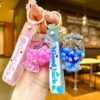 Wholesale Oil filled luminous colorful candy quicksand bottle keychain