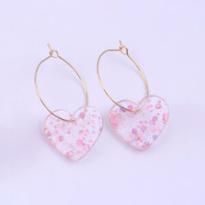 A pair of pink sequined love earrings