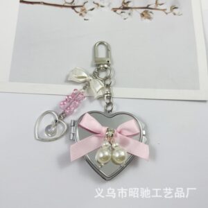 Large heart-shaped pink ribbon bow mirror