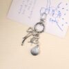 O1CN01WP23Y41WtWK4bwEzo_2220577792846-0-cib Wholesale Creative Ocean Beach Tower Shell Metal Keychain