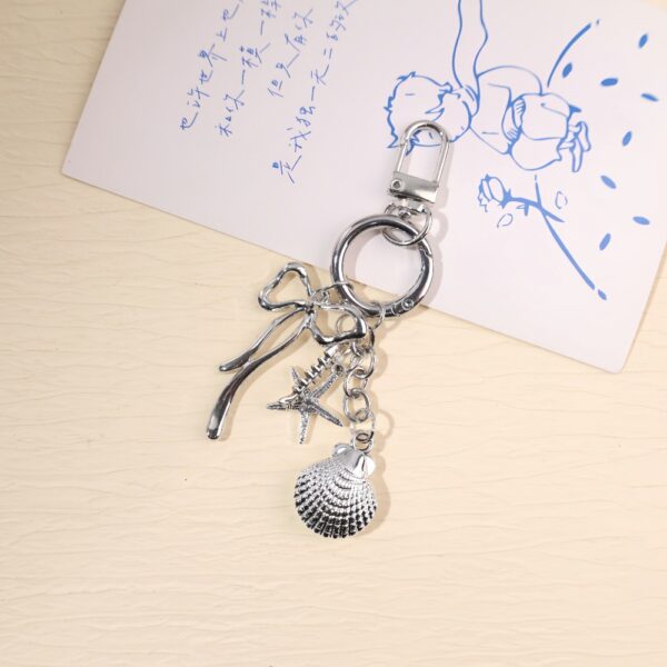O1CN01WP23Y41WtWK4bwEzo_2220577792846-0-cib Wholesale Creative Ocean Beach Tower Shell Metal Keychain