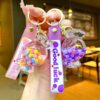 Wholesale Oil filled luminous colorful candy quicksand bottle keychain