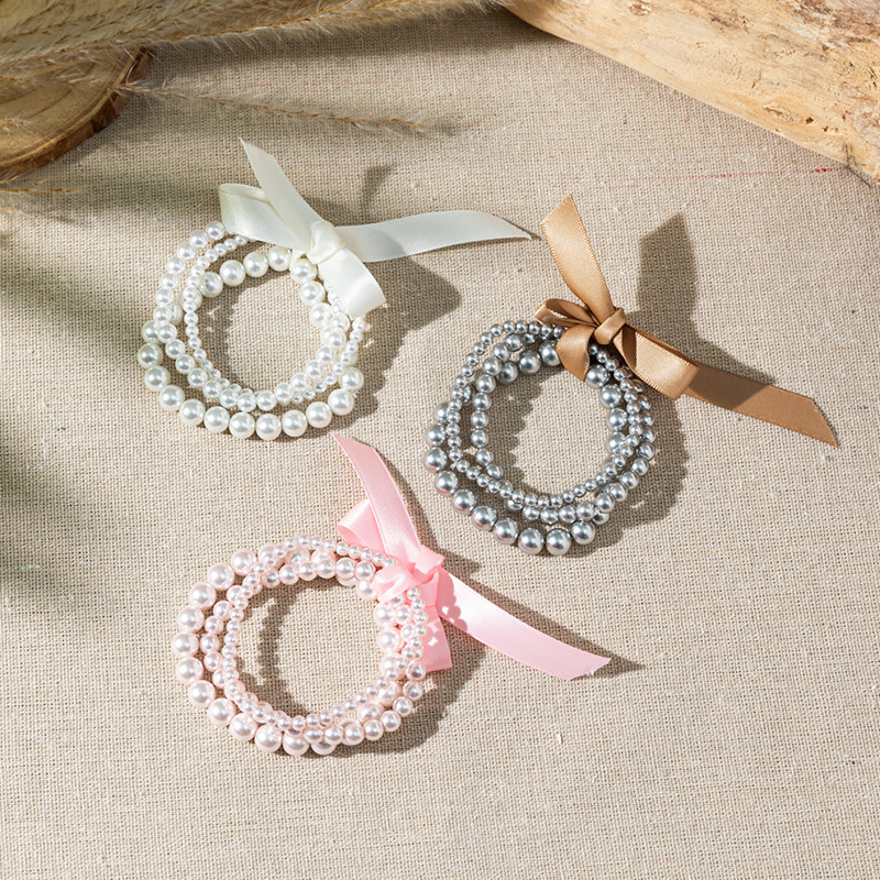 Wholesale Bow colored pearl multi-layer layered bracelet