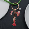 Wholesale Cross-border oil drop red alloy princess dress model hat high heels pearl keychain niche jewelry pendant