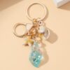 Wholesale Seaside vacation luminous conch metal keychain