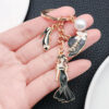 O1CN01jCy4It2Kpbd3YFqkA_2217654629606-0-cib Wholesale Cross-border oil-dripping black princess dress model small fragrant style hat high heels keychain exquisite jewelry key chain