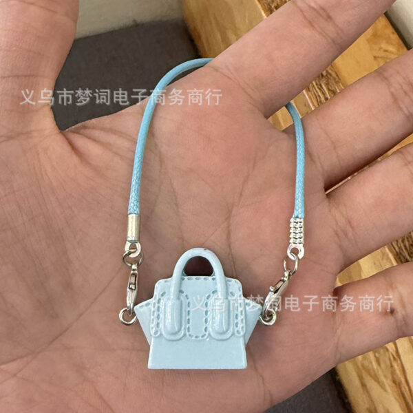 O1CN01kZNRCs29F0HLX9tfM_2216239028037-0-cib Wholesale Miniature doll keychain bag charm resin accessory OLY Exclusive