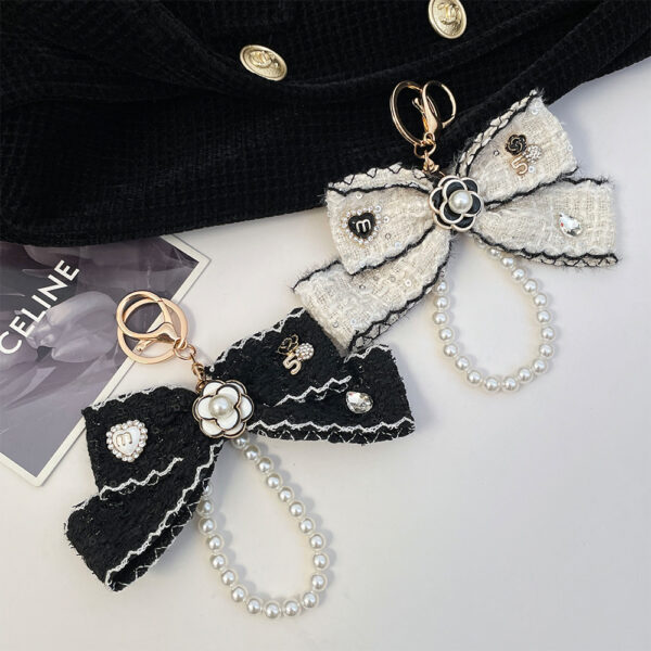 Wholesale Black and white color Chanel style camellia pearl chain bow keychain
