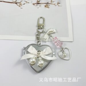 Large heart-shaped white ribbon bow mirror
