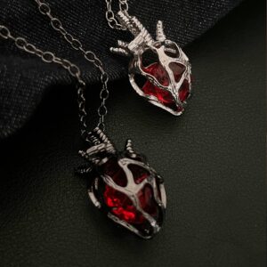O1CN01t1ho4L1l7d8YDJqUu_2216037694772-0-cib Wholesale Gothic dark style hollow heart red blue glass heart pendant necklace