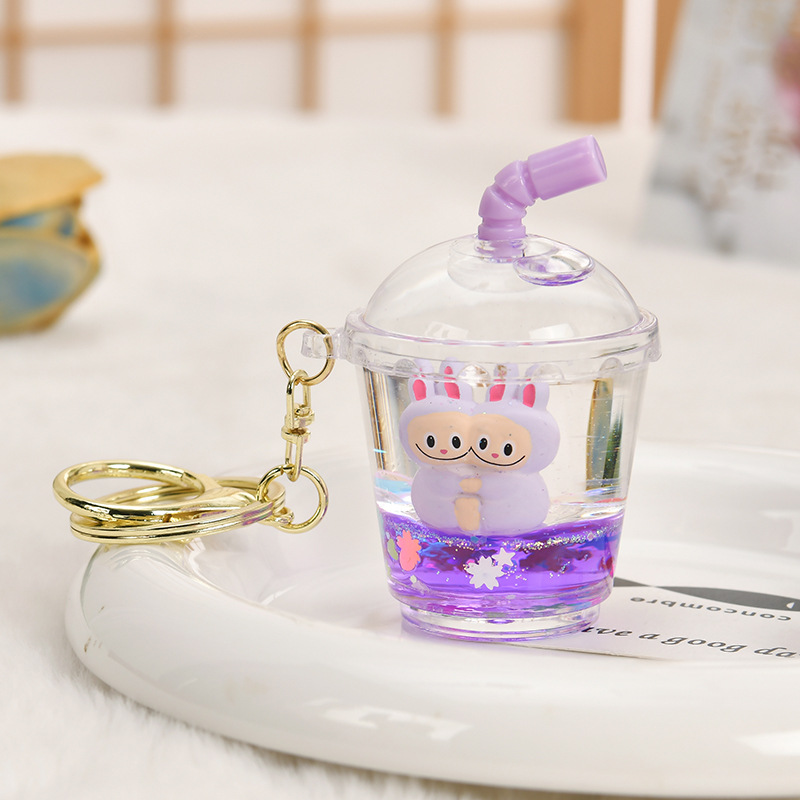 Wholesale Oil-filled acrylic doll cylinical c with flowing sand bottle keychain