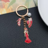 Wholesale Cross-border oil drop red alloy princess dress model hat high heels pearl keychain niche jewelry pendant