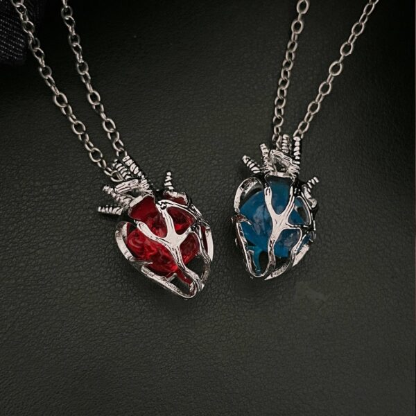 O1CN01vipFuS1l7d8Ye1GcH_2216037694772-0-cib Wholesale Gothic dark style hollow heart red blue glass heart pendant necklace