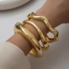 O1CN01xqCM711lWouHvruCU_2218670844827-0-cib Wholesale Golden wide edged wave band exaggerated bracelet