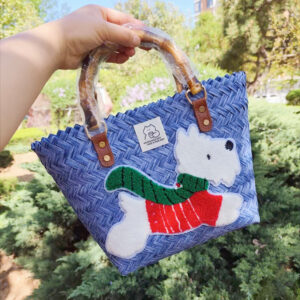 Blue bamboo handle basket with green scarf dog