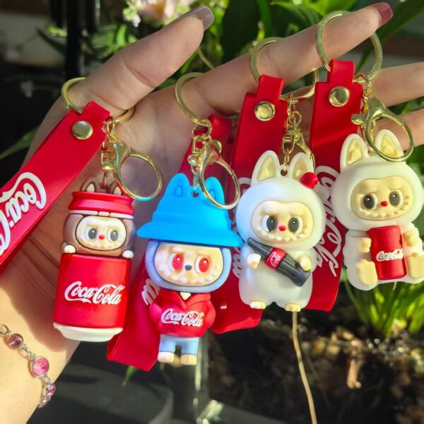 oly-1627980111d1c6c22644f46894491bee Wholesale Cross-Border Popular Coke Tooth Labubu Keychain Cartoon Couple Doll Pendant Bag Pendant