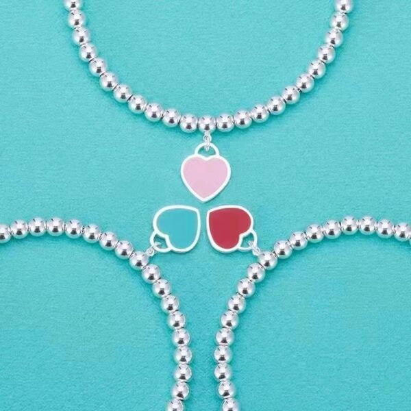Wholesale brass-plated sier heart bracelet with enamel blue, red, and pink hearts. High-value women's bracelet, opshipping available.