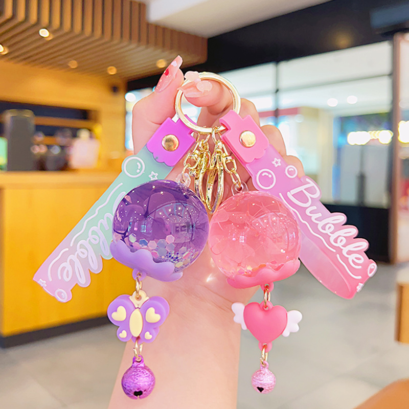Wholesale Cross-border cartoon oil ied flower quicksand ball keychain wind bell flower pendant acrylic jewelry quicksand bottle