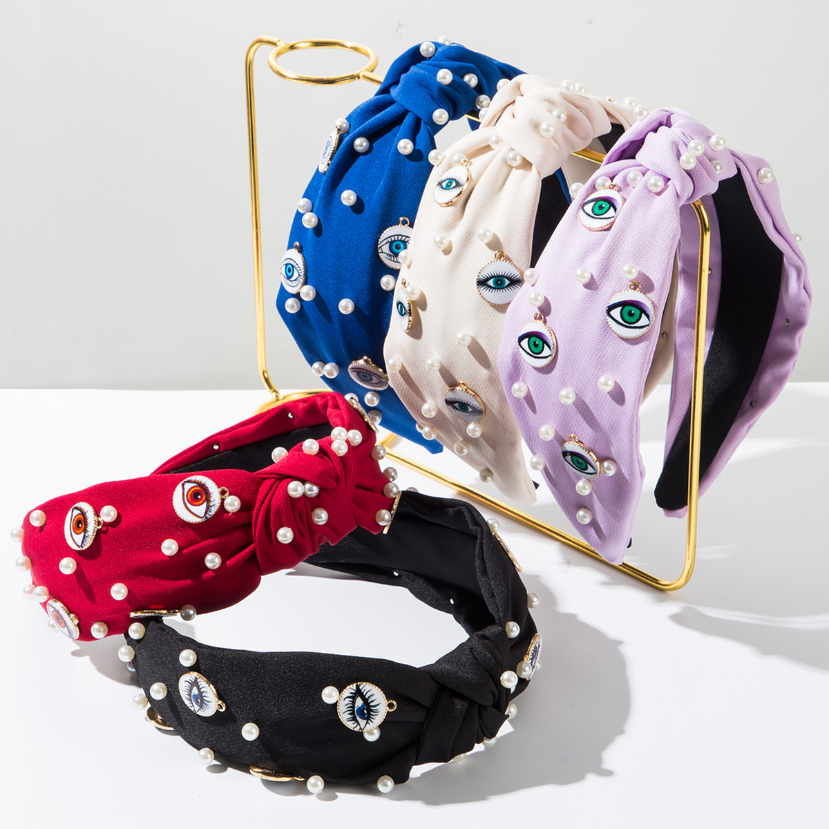 Wholesale Korean style elegant fabric headband studded with pearls, round evil eye design, fashionable wide-brimmed knotted hair aessory for women.