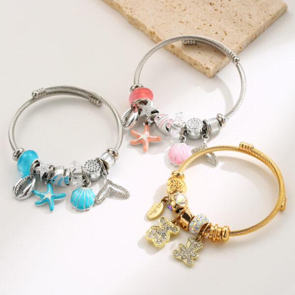 Wholesale Stainless steel bracelet with starfish, seashell, bear pendant, and heart-shaped charm for women.