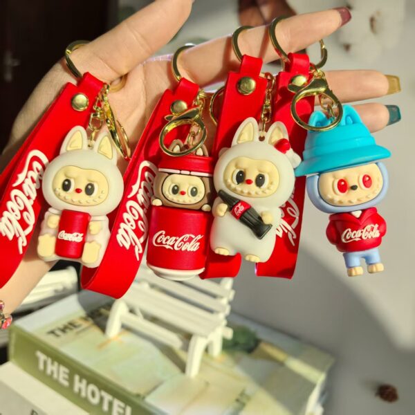 oly-39ecb66310d840a588b3de75495fdf14 Wholesale Cross-Border Popular Coke Tooth Labubu Keychain Cartoon Couple Doll Pendant Bag Pendant