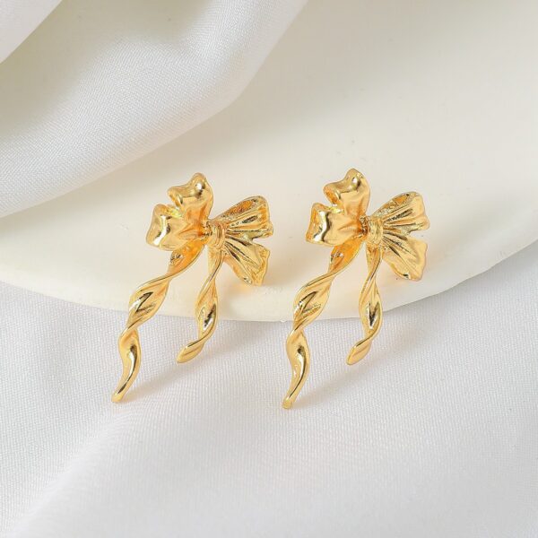 oly-3a331f61d0d57d6fb04997471ee779b1 Wholesale European and American Cross-Border Hot-Selling Environmentally Friendly Alloy Gold Bow Personalized Fashion Trend Earrings Earrings Design Niche