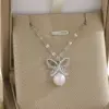 Wholesale Rack Plated 18K Gold Cross Flower Butterfly 201 Stainless Steel Imitation Pearl Zinc Alloy Simple Style Classic Pendant Necklace