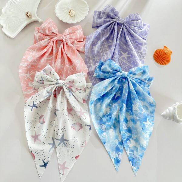 Wholesale Summer beach hair clip with starfish and seashell print, long ribbon bow, spring clip, stylish hair accessory for women.