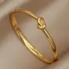 Wholesale 304 Stainless Steel Twist Ion Plating (IP) Real Gold Plated Simple Style Classic Style Waterproof Non Tarnish Asymmetrical Buckle Gold Bangle